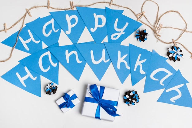 Free photo top view gifts and happy hanukkah garland