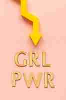 Free photo top view of girl power with arrow for women's day