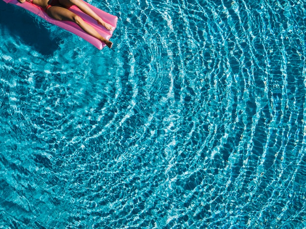 Free photo top view of girl relaxing on inflatable mattress