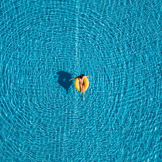 Top view of girl relaxing on inflatable ring