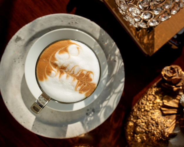 Free Photo top view of a glass of coffee with latte art