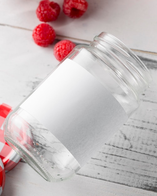 Free photo top view of glass jar with raspberries