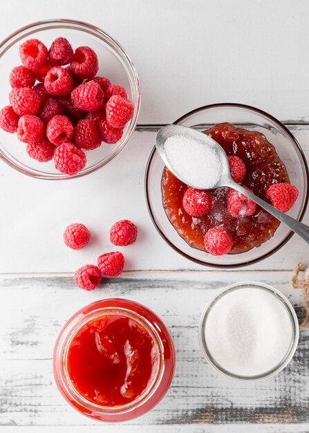 Top view of glass jar with raspberry jam and fruits