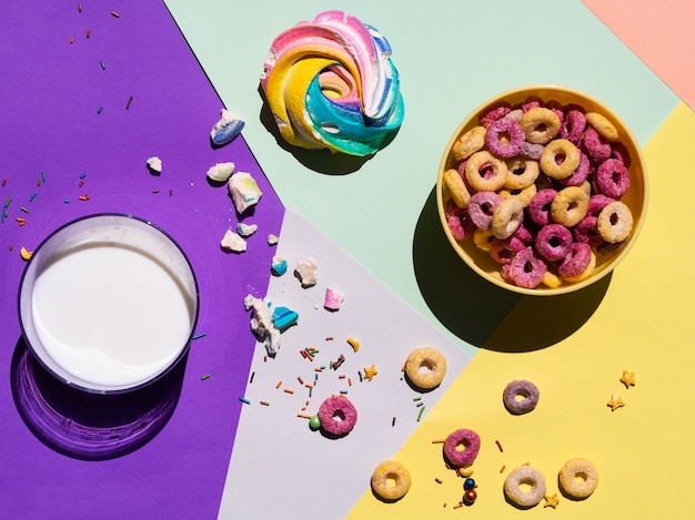 Free photo top view glass of milk and some cereals around