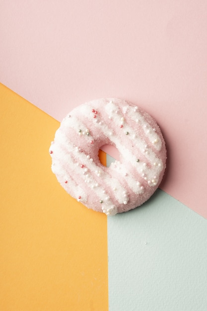 Free Photo top view of glazed doughnut with multicolored background