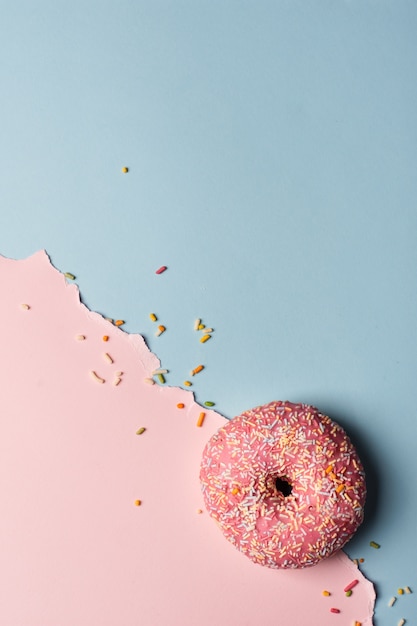 Free photo top view of glazed doughnut with sprinkles and copy space