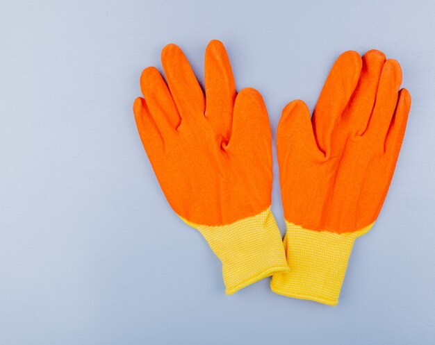 Top view of gloves on gray background with copy space