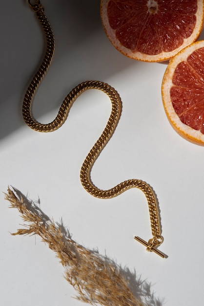 Free photo top view gold chain and citrus