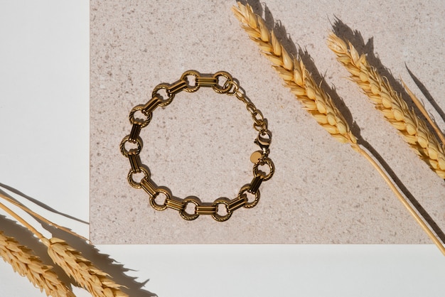 Top view gold chain and wheat still life