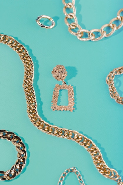 Top view on gold chains still life