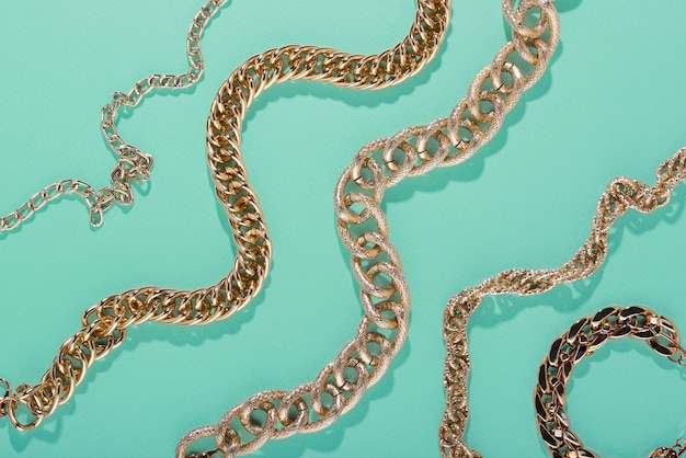 Top view on gold chains still life