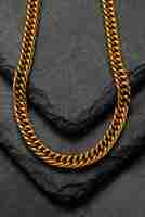 Free photo top view golden chain and dark rock