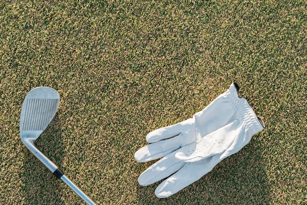 Top view golf club and glove