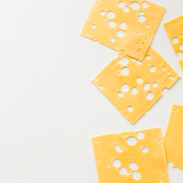 Top view gourmet emmental cheese slices with copy spaces