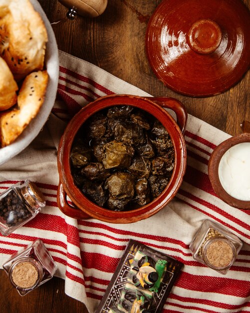 Top view of grape leaves dolma served with yogurt