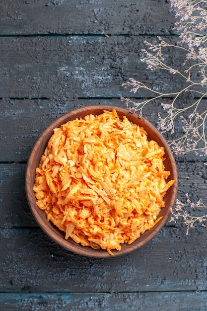 Free Photo top view grated carrot salad inside brown plate on the dark-blue rustic desk health salad color ripe diet vegetable