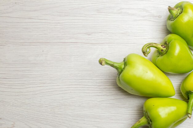 Top view green bell-peppers on white background