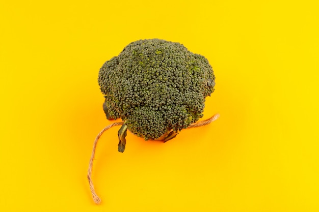 top view green broccoli ripe fresh isolated on the yellow background