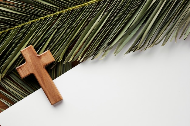 Top view green leaves and cross arrangement