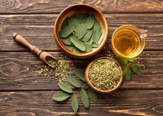 Free photo top view green leaves and cup of tea