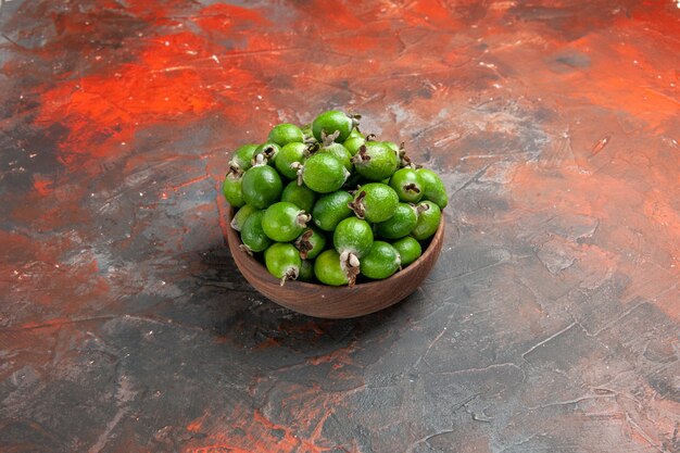 Top view of green small vitamin bomb fresh feijoas in a brown pot