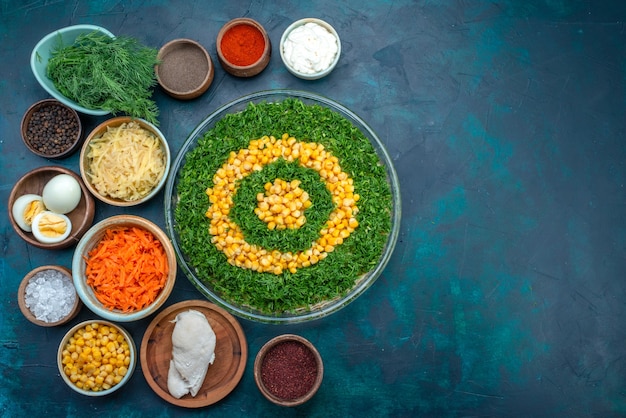 Free photo top view greens salad with corns along with with seasonings and eggs on the dark-blue background.