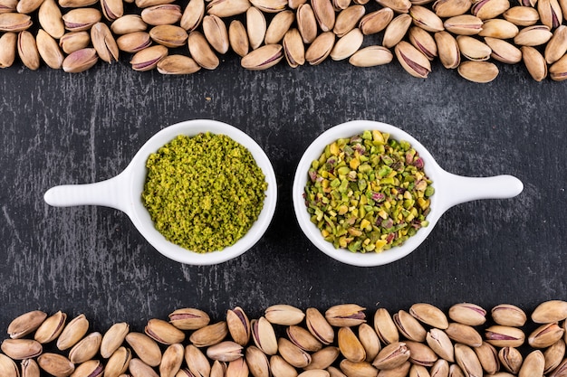 Free Photo top view ground, milled, crushed pistachios in a bowl on gray texture