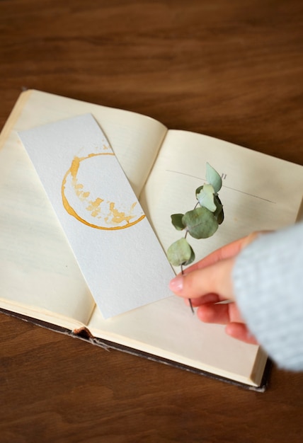 Free Photo top view hand holding bookmark