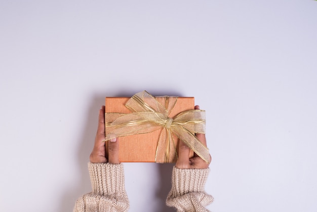 Top view Hand holding gift box on work space