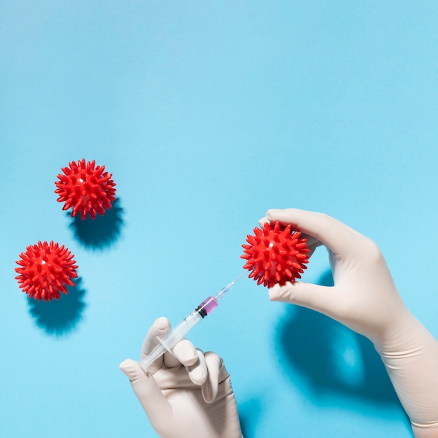 Free photo top view of hand holding virus with syringe