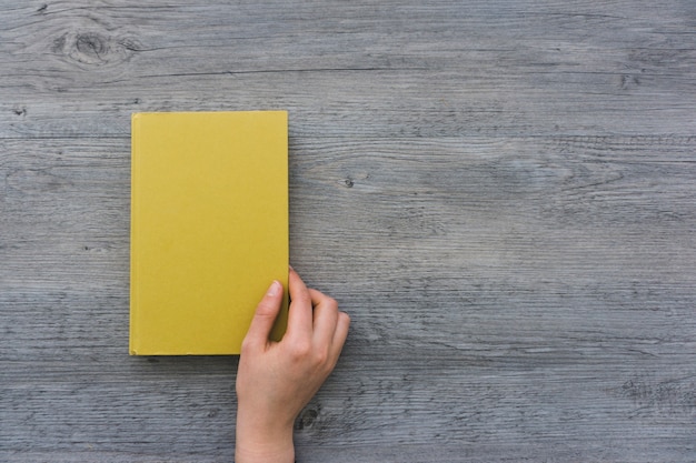 Top view of hand opening a book