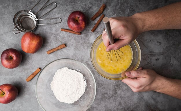 Top view hand whisking bowl with egg