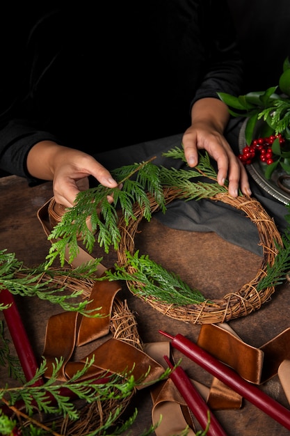 Free photo top view hands assembling  advent wreath