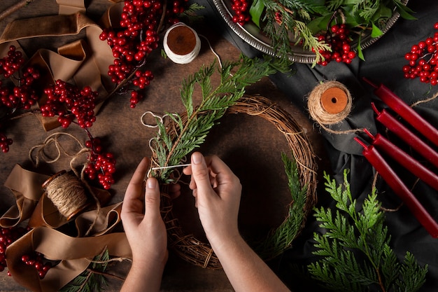 Free photo top view hands assembling  advent wreath