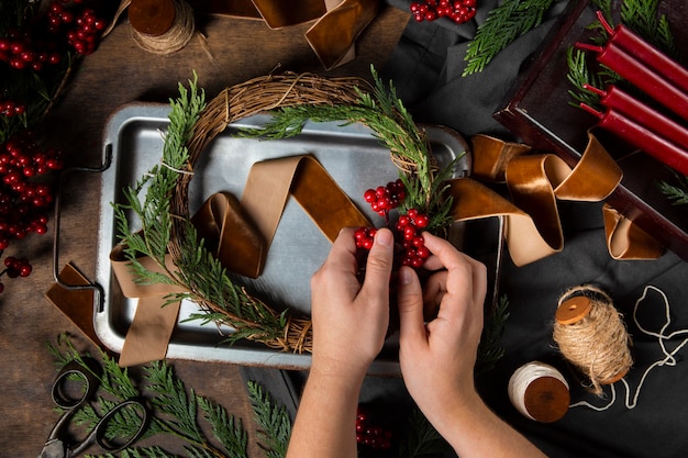 Free photo top view hands assembling  advent wreath