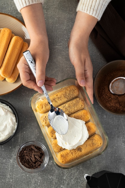 Top view hands cooking tiramisu