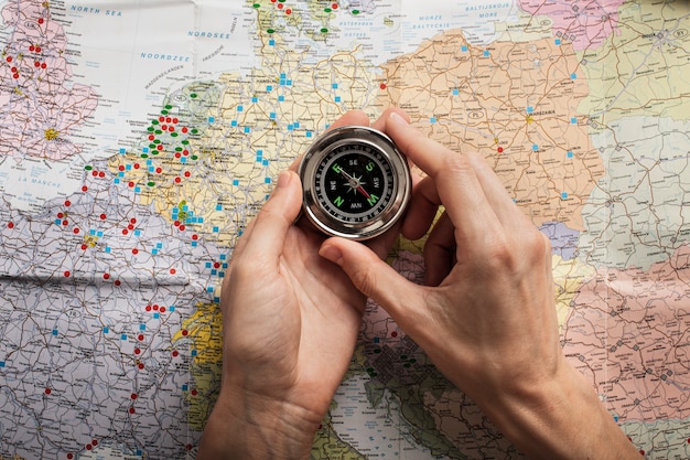 Top view hands holding compass