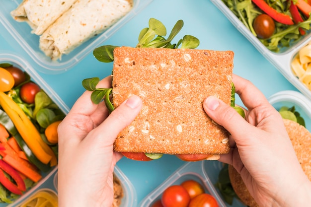 Top view hands holding cracker sandwich