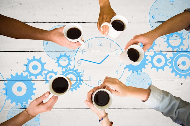 Free photo top view of hands holding cups of coffee with a painted clock background