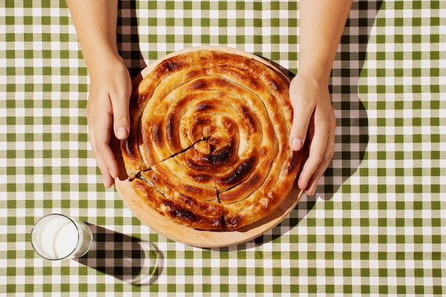 Top view hands holding delicious pie