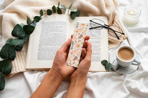 Top view hands holding floral bookmark