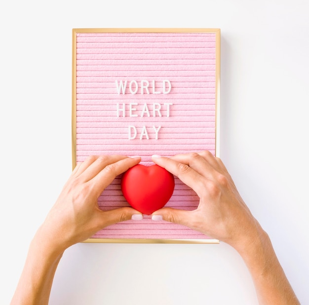 Free Photo top view of hands holding heart shape for world heart day