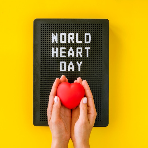 Free Photo top view of hands holding heart for world heart day