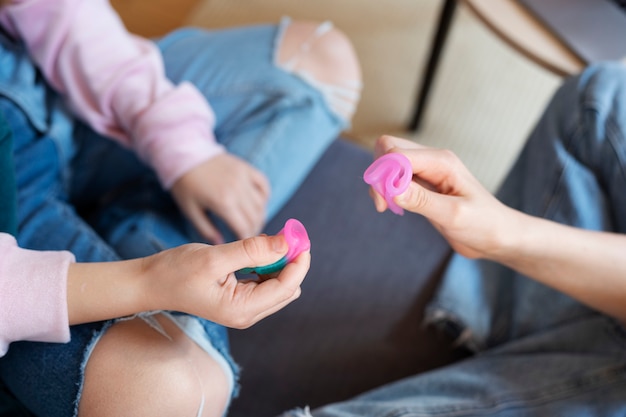 Top view hands holding menstrual cups