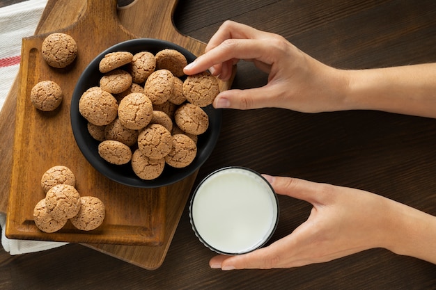 Top view hands holding milk and pepernoten