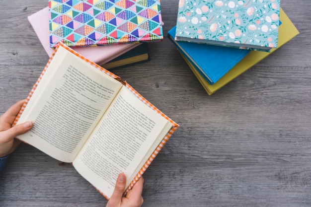 Top view of hands holding an open book