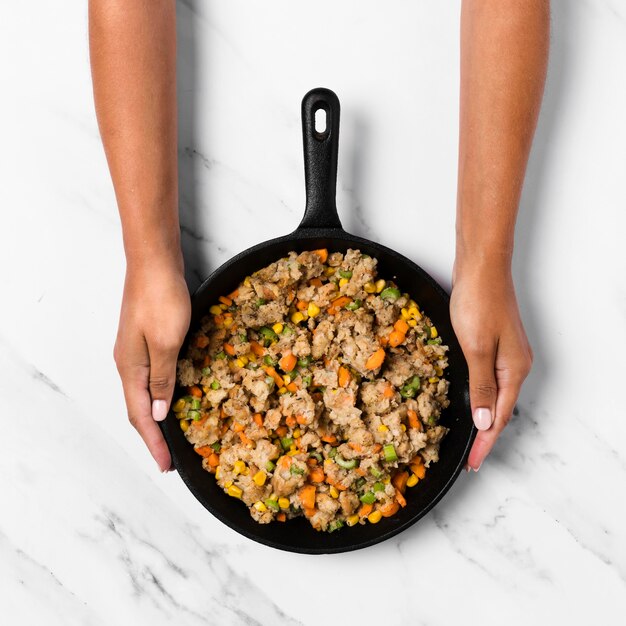 Top view hands holding pan with stuffing