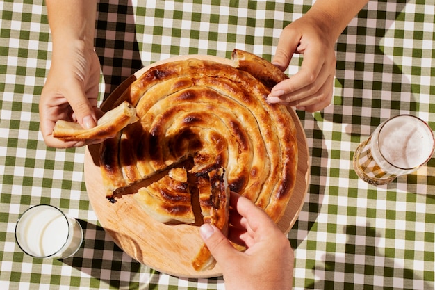 Free photo top view hands holding pie slices