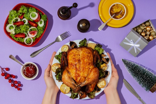 Top view hands holding plate with food