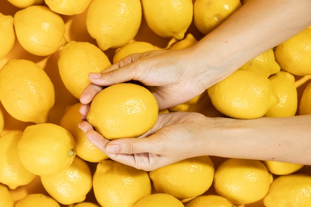 Top view hands holding raw lemon